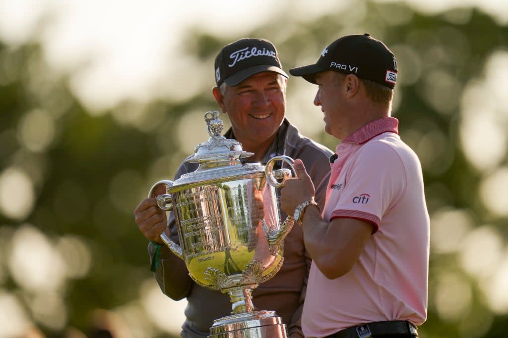 Justin Thomas poses with the Wanamaker Trophy with his father Mike after winning the US PGA Championship (Sue Ogrocki/AP) (AP)