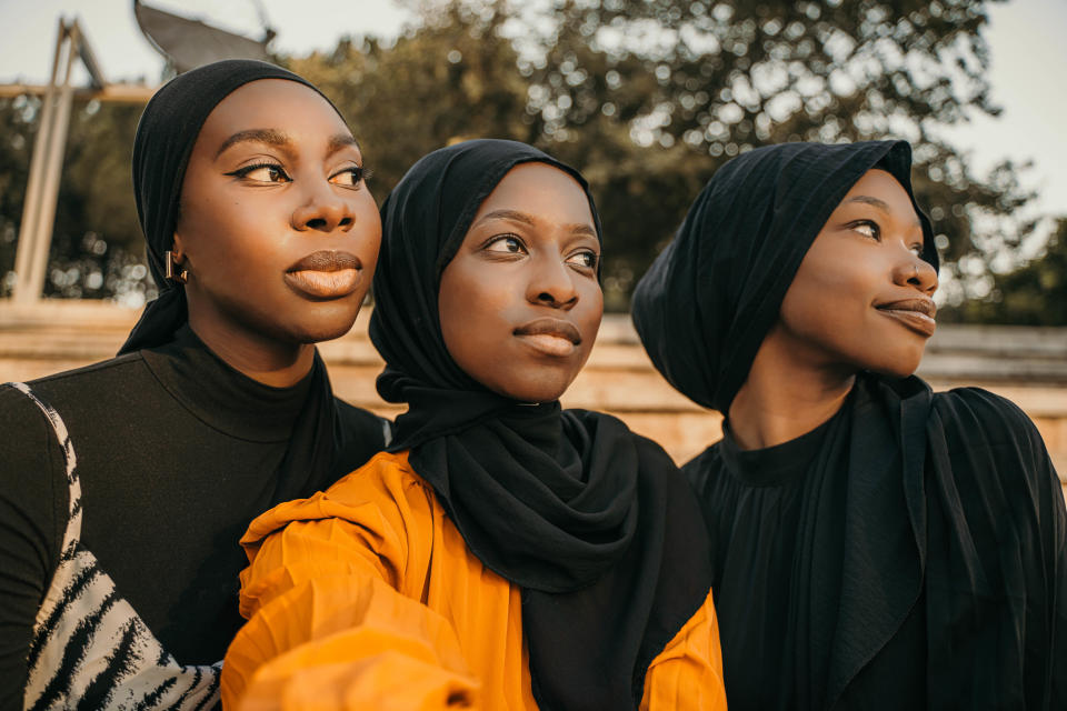three black Muslim women looking to the side