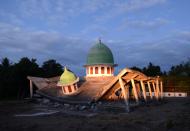 <p>A collapsed mosque is seen as the sun set at Kayangan subdistrict in North Lombok on West Nusa Tenggara province on Aug. 8, 2018, (Photo: Sonny Tumelaka/AFP/Getty Images) </p>