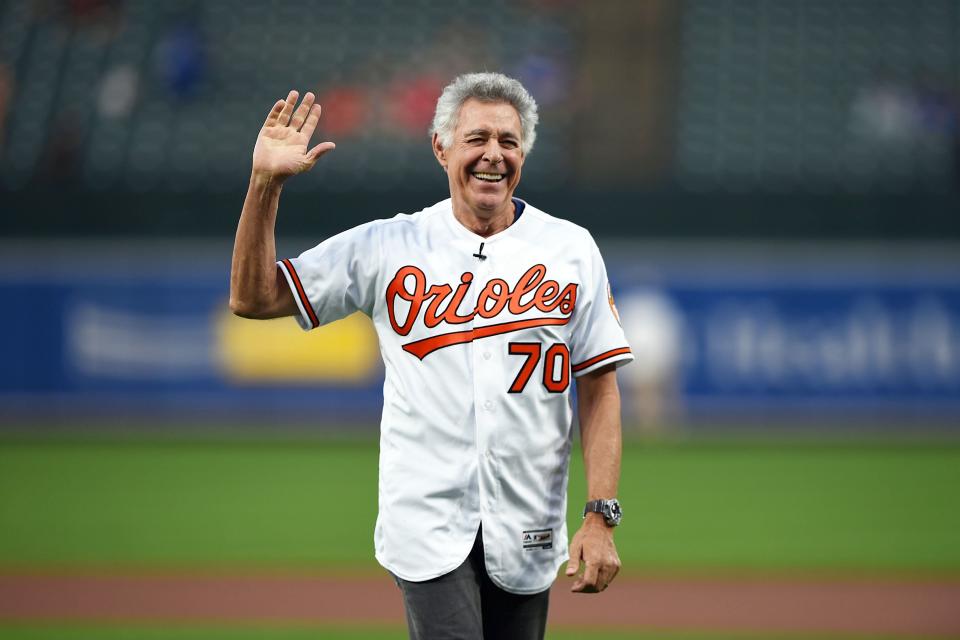 <em>The Brady Bunch</em> star Barry Williams waves to the crowd after throwing out the ceremonial first pitch before the Los Angeles Dodgers vs. Baltimore Orioles baseball game on Thursday in Baltimore, Maryland.