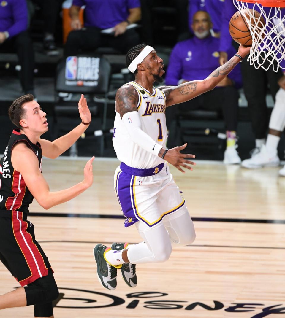 The Lakers' Kentavious Caldwell-Pope beats the Heat's Duncan Robinson to the basket