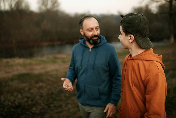 Dad and teen son talking