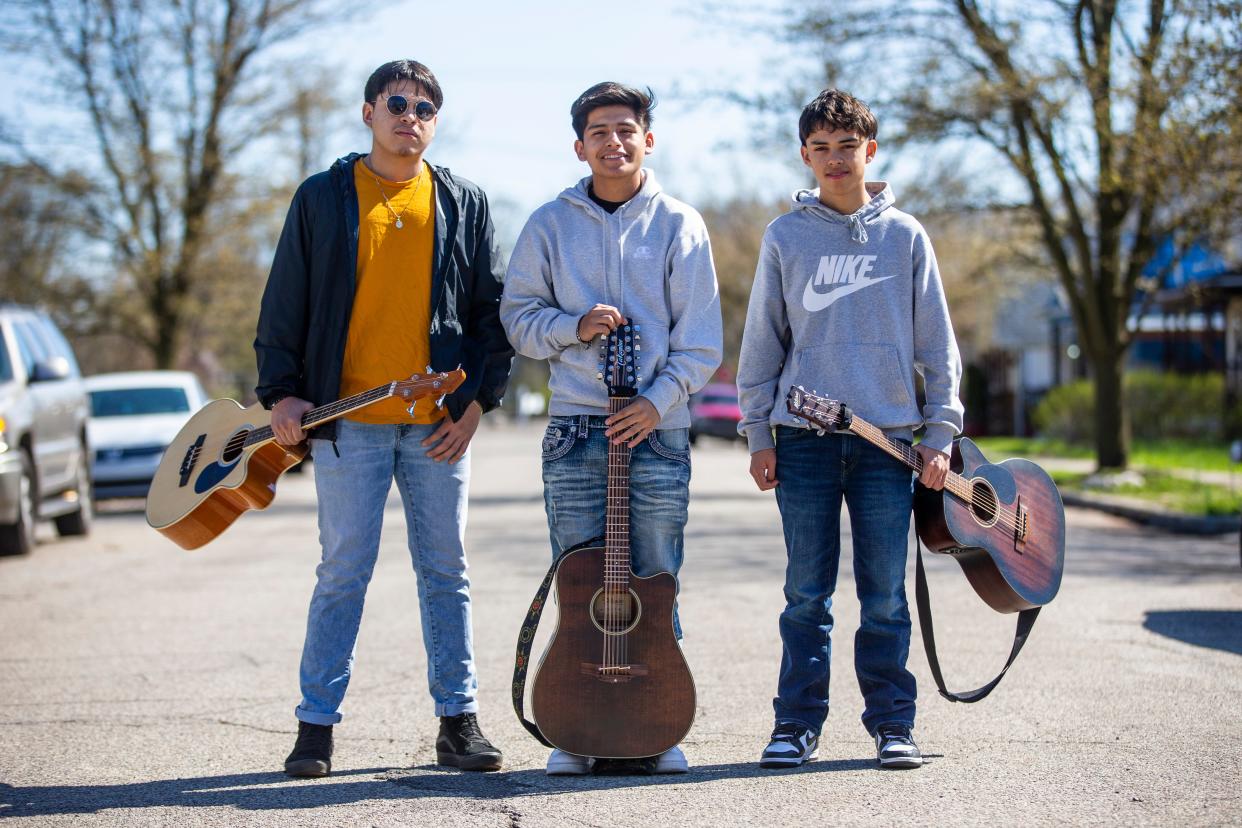 Members of the group Los de San Rafael, from left, Gabriel Saenz, Isac Ruelas and Moises Ruelas pose April 21 on the westside street in South Bend where the Ruelas brothers live.