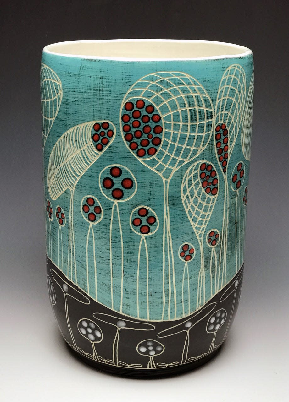 A turquoise vase with amoebas was created by artist Marcy Neiditz, a member of the  Local Clay Potters Guild in Bloomington.