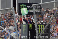 Pastor of First Baptist Church Dallas Dr. Robert Jeffress waves the green flag for the start of a NASCAR Cup Series auto race at Talladega Superspeedway, Sunday, Oct. 13, 2019, in Talladega, Ala. (AP Photo/Butch Dill)
