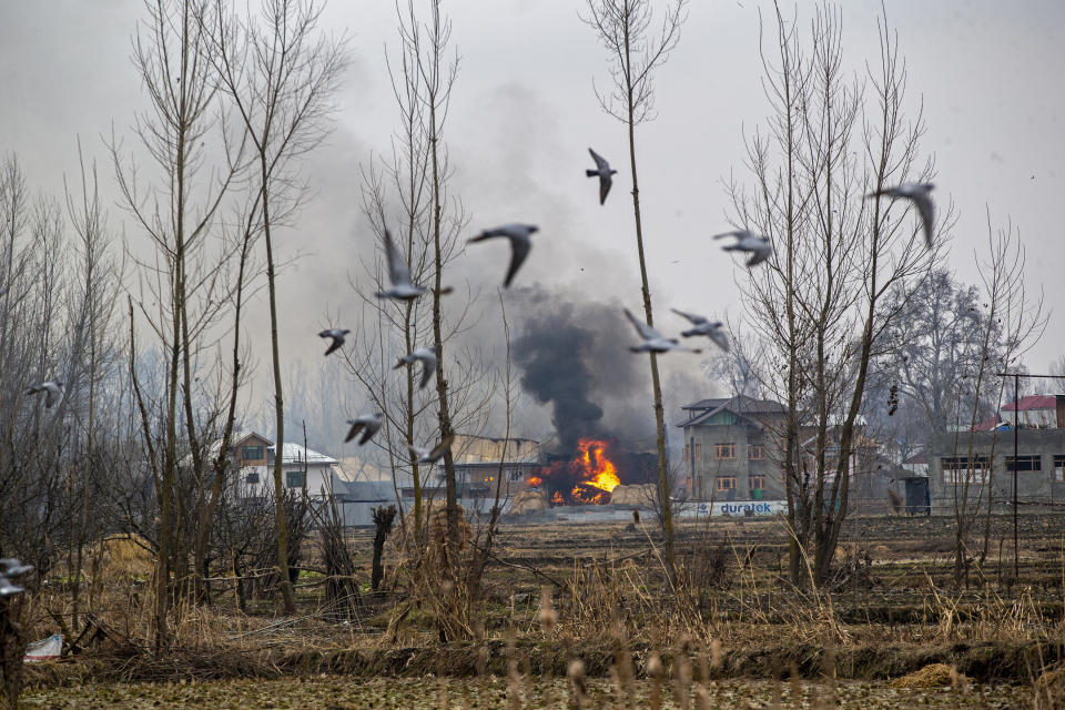 Flames and smoke billow from a residential building where militants are suspected to have taken refuge during a gun battle in Pulwama, south of Srinagar, Indian controlled Kashmir, Feb. 18, 2019. The image was part of a series of photographs by Associated Press photographers which won the 2020 Pulitzer Prize for Feature Photography. (AP Photo/Dar Yasin)