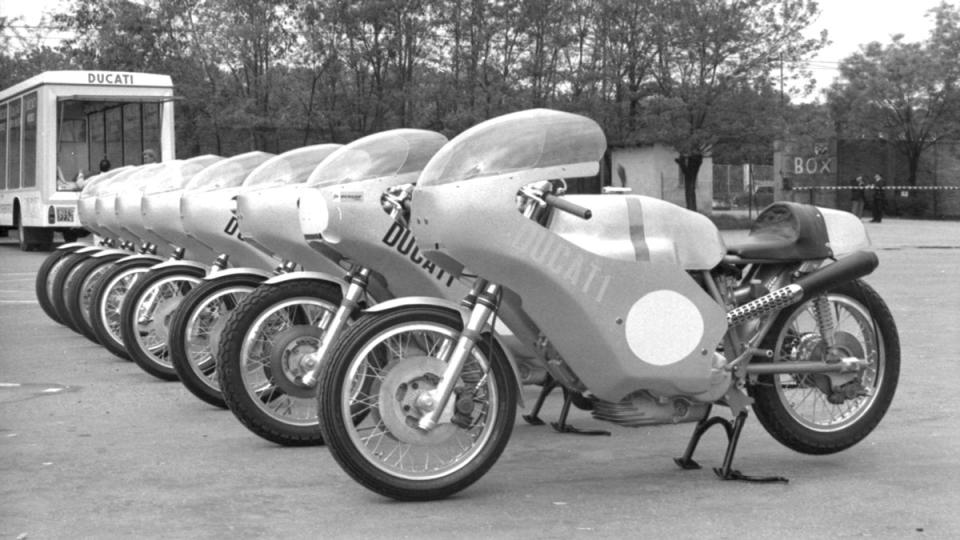 Ducati's lineup of 750 Imola Desmo race bikes, with their glass-sided transport, at the 1972 Imola 200.