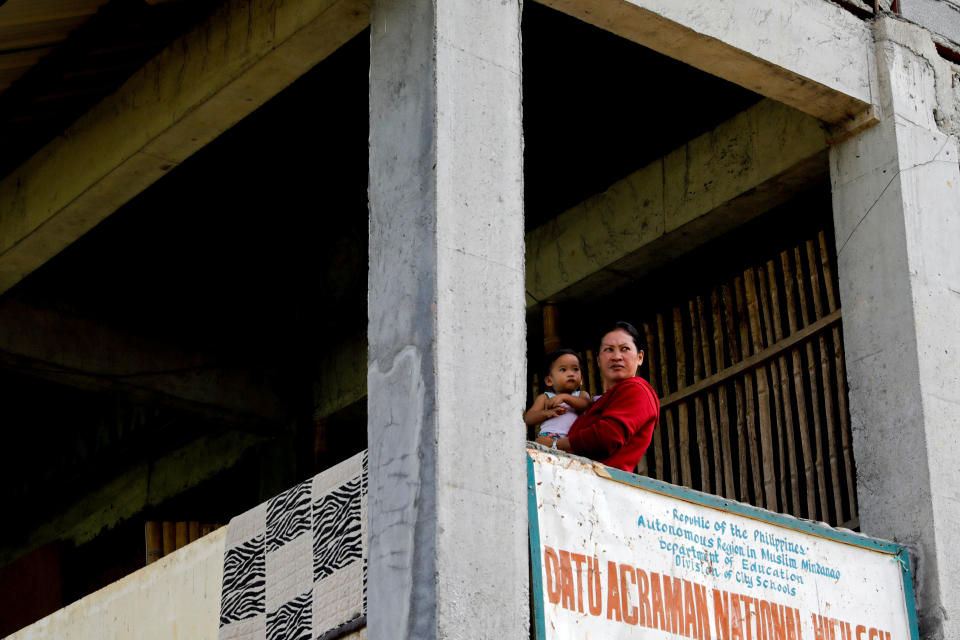 Marie Dalama Acampong, 37, carries her 1-year-old daughter Norlaila at the school-turned-evacuation center in Mipaga, Marawi City, Lanao del Sur province, Philippines. (Photo: Eloisa Lopez/Reuters)