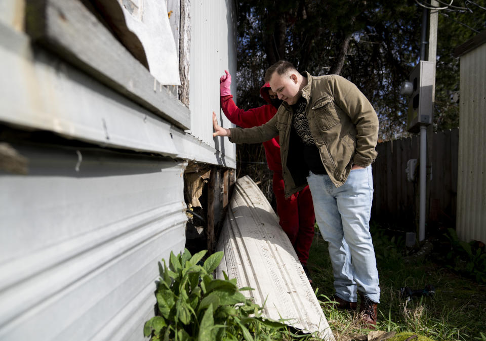 Gadiel Galvez, 22, checks on a water issue at a neighbor’s home at Bob’s and Jamestown Homeowners Cooperative, a resident-owned mobile home park in Lakewood, Wash., on Saturday, March 25, 2023. When residents learned the park’s owner was looking to sell, they formed a cooperative and bought it themselves amid worries it would be redeveloped. Since becoming owners in September 2022, residents have worked together to manage and maintain the park. (AP Photo/Lindsey Wasson)
