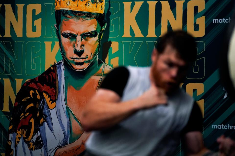 Unified WBC/WBO/WBA super middleweight champion Canelo Alvarez trains in front of an image of himself at a gym Wednesday, Oct. 20, 2021, in San Diego. Alvarez faces undefeated IBF Super Middleweight Champion Caleb Plant in a fight Nov. 6 in Las Vegas. (AP Photo/Gregory Bull)