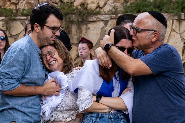 <p>Alexi J. Rosenfeld/Getty</p> A family mourns a loved one in Israel