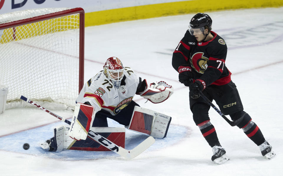 Ottawa Senators center Ridly Greig tries to deflect a shot past Florida Panthers goaltender Sergei Bobrovsky during the first period of an NHL hockey game Thursday, April 4, 2024, in Ottawa, Ontario. (Adrian Wyld/The Canadian Press via AP)