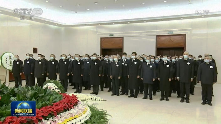 In this image taken from video footage run by China's CCTV, Chinese President Xi Jinping, center left, and his predecessor Hu Jintao, center right, accompanied by leaders pay respect to remain of former president Jiang Zemin before sent for cremation at Babaoshan cemetery, at a military hospital in Beijing, Monday, Dec. 5, 2022. Chinese President Xi Jinping and other current and previous top officials paid their respects Monday to former leader Jiang Zemin, who died last week at age 96. (CCTV via AP)
