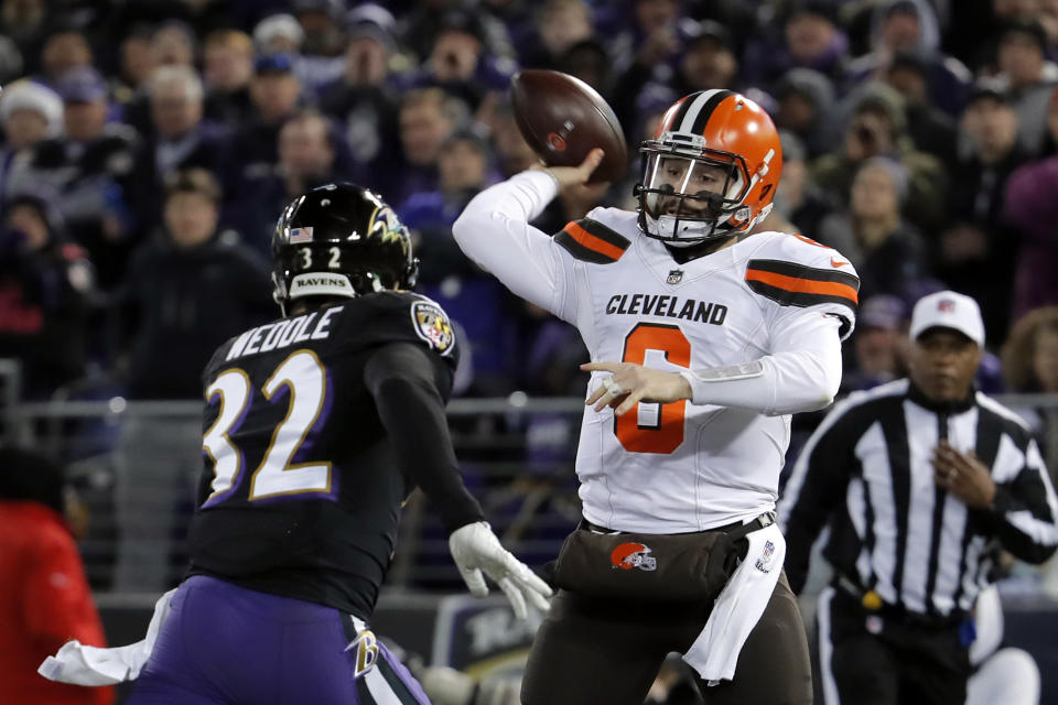 Cleveland Browns quarterback Baker Mayfield, right, throws a pass as he is pressured by Baltimore Ravens free safety Eric Weddle in the first half of an NFL football game, Sunday, Dec. 30, 2018, in Baltimore. (AP Photo/Carolyn Kaster)