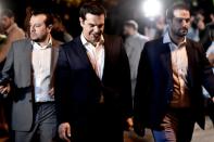 Greek Prime Minister Alexis Tsipras (C) heads to a meeting with the president in Athens on July 5, 2015 after voters overwhelmingly rejected international creditors' tough bailout terms