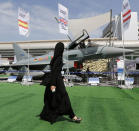 <p><span>A woman walks past a Eurofighter Typhoon aircraft on display at a military show launching the International Defence Exhibition and Conference (IDEX) at the Abu Dhabi National Exhibition Centre in the Emirati capital on February 17, 2013. </span></p>