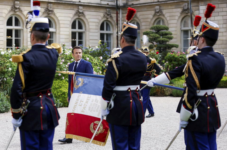 French President Emmanuel Macron reviews military troops during the ceremony of his inauguration for a second term at the Elysee palace, in Paris, France, Saturday, May 7, 2022. Macron was reelected for five years on April 24 in an election runoff that saw him won over far-right rival Marine Le Pen. (Gonzalo Fuentes/Pool via AP)