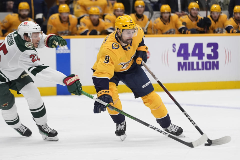 Nashville Predators left wing Filip Forsberg (9) skates the puck past Minnesota Wild defenseman Jonas Brodin (25) during the second period of an NHL hockey game Thursday, Feb. 29, 2024, in Nashville, Tenn. (AP Photo/George Walker IV)