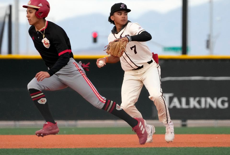 Hamilton's AJ Diaz (7) throws to first while Orange Lutheran's Derek Curiel (4) runs to third base during a high school baseball game at Bell Bank Park Legacy Sports Complex in Mesa on Feb. 23, 2023.