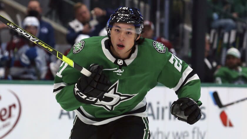 Dallas Stars left wing Jason Robertson (21) skates down the ice at an NHL preseason hockey game against the Colorado Avalanche Thursday, Oct. 7, 2021, in Dallas. (AP Photo/Richard W. Rodriguez)