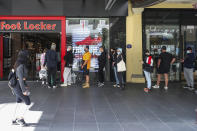 Customers line up outside a sportswear retailer in Melbourne, Australia, Wednesday, Oct. 28, 2020. Australia’s second largest city of Melbourne which was a coronavirus hotspot emerges from a nearly four-months lockdown, with restaurants, cafes and bars opening and outdoor contact sports resuming on Wednesday. (AP Photo/Asanka Brendon Ratnayake)