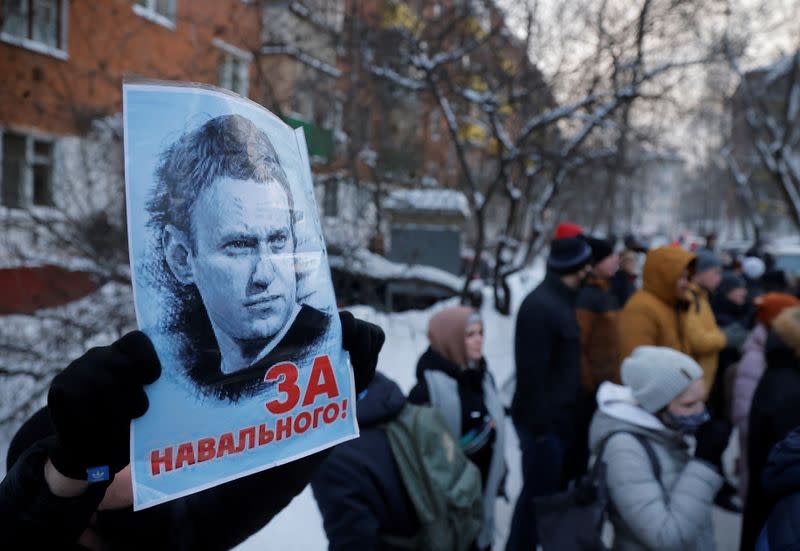 People, including supporters of Alexei Navalny, gather outside a police station where the opposition leader is being held following his detention, in Khimki 