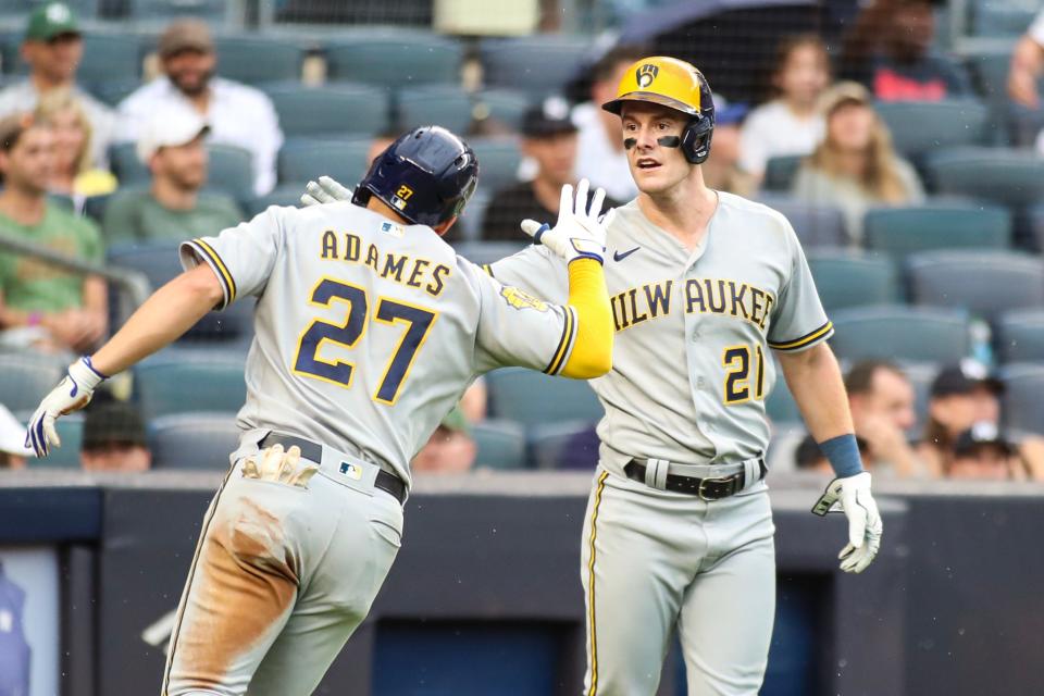 Sep 9, 2023; Bronx, New York, USA;  Milwaukee Brewers shortstop Willy Adames (27) is greeted by right fielder Mark Canha (21) after hitting an RBI triple and scoring on an error in the fourth inning against the New York Yankees at Yankee Stadium. Mandatory Credit: Wendell Cruz-USA TODAY Sports