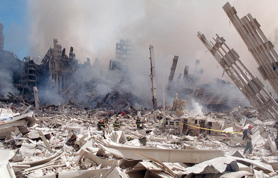 FILE — In this Sept. 12, 2001 file photo, firefighters work in the rubble of the World Trade Center towers in New York. Two decades after the twin towers' collapse, people are still coming forward to report illnesses that might be related to the attacks. (AP Photo/Virgil Case, File)