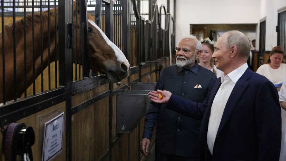 Russian President Vladimir Putin and Indian Prime Minister Narendra Modi visit a stable during an informal meeting outside Moscow, on July 8, 2024. - Gavrill Grigorov/Pool/AFP/Getty Images