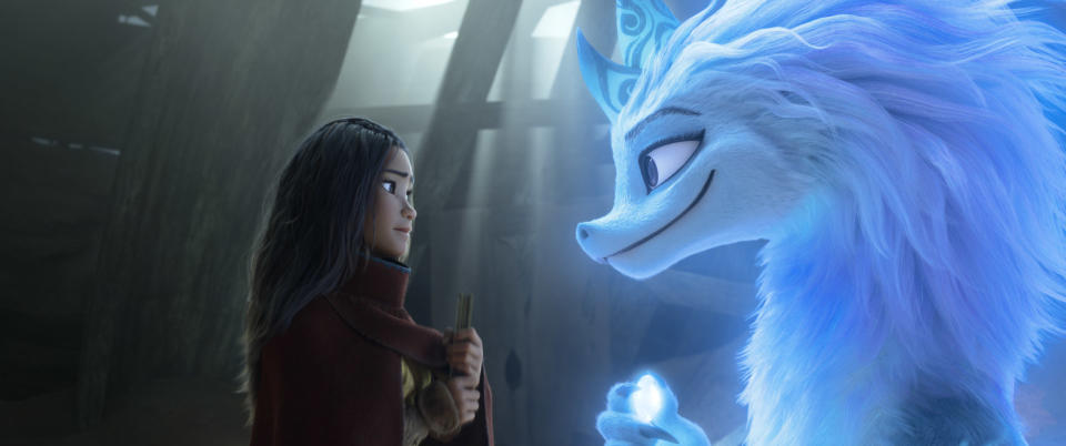 Animated character Raya, voiced by Kelly Marie Tran, left, appears with Sisu the dragon in a scene from "Raya and the Last Dragon." (Disney+ via AP)