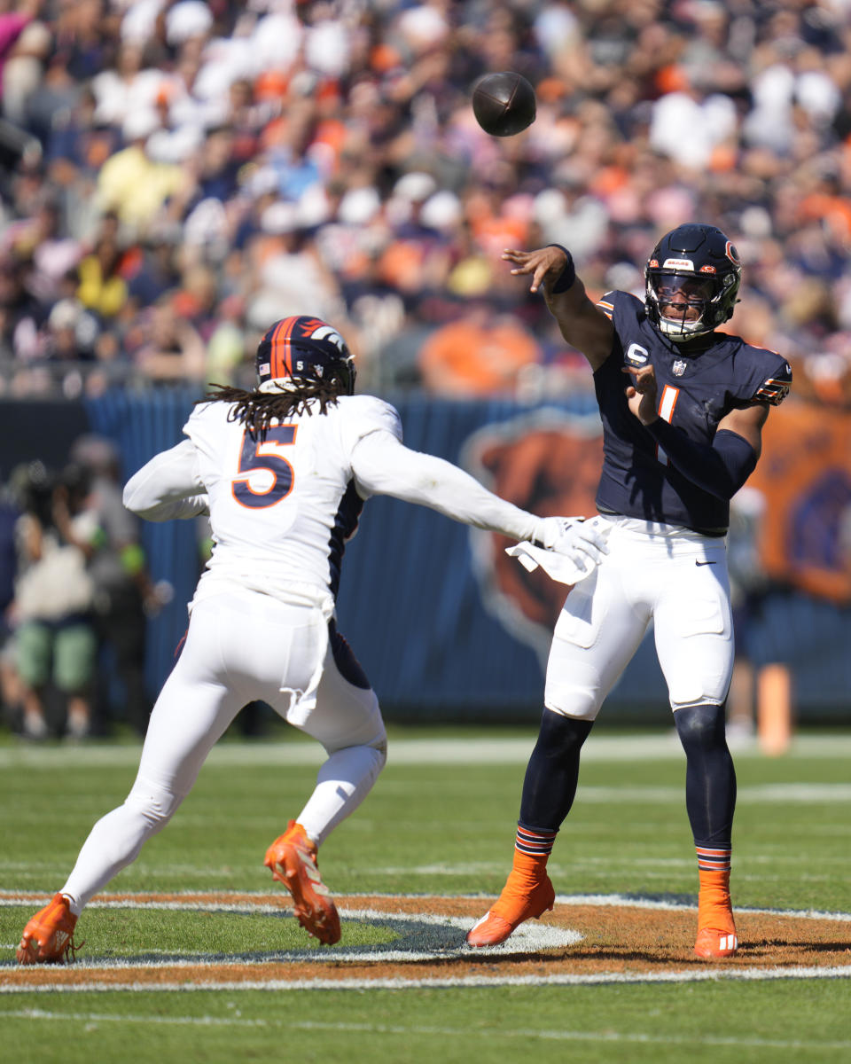 Chicago Bears quarterback Justin Fields passes under pressure from Denver Broncos linebacker Randy Gregory during the first half of an NFL football game Sunday, Oct. 1, 2023, in Chicago. (AP Photo/Erin Hooley)