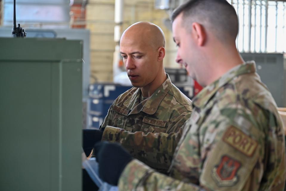 U.S. Air Force Staff Sgt. Vonodrous Broughton and Airman Devin Lincoln, 25th Aerial Port Squadron air transportation specialists, prepare cargo for transport to the aircraft during the unit training assembly on March 11, 2023, at Maxwell Air Force Base, Alabama. This training was part of a multi-day exercise for member of 25 APS to learn to load and unload aircraft from the side.