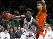 Notre Dame's Temple 'T.J.' Gibbs (10) drives in next to Miami's Isaiah Wong (2) during the second half of an NCAA college basketball game Sunday, Feb. 23, 2020, in South Bend, Ind. (AP Photo/Robert Franklin)