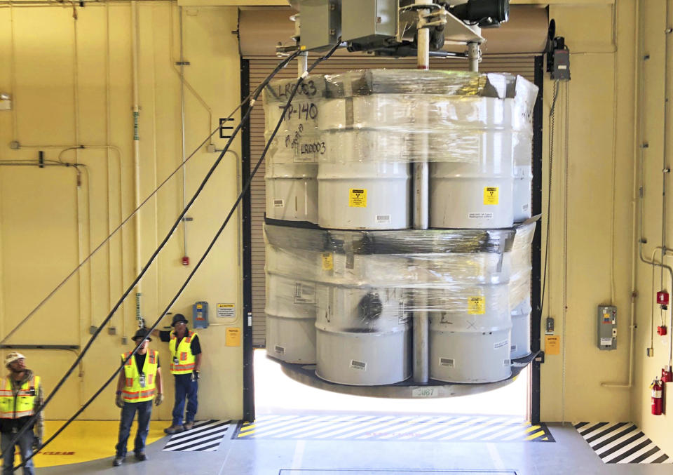 FILE - In this Tuesday, April 9, 2019 file photo, provided by Los Alamos National Laboratory, barrels of radioactive waste are loaded for transport to the Waste Isolation Pilot Plant, marking the first transuranic waste loading operations in five years at the Radioactive Assay Nondestructive Testing (RANT) facility in Los Alamos, N.M. A fight is raging in courts and Congress over where radioactive materials should be stored and how to safely get the dangerous remnants of decades of bomb-making and power generation to a permanent resting place. (Nestor Trujillo/Los Alamos National Laboratory via AP, File)