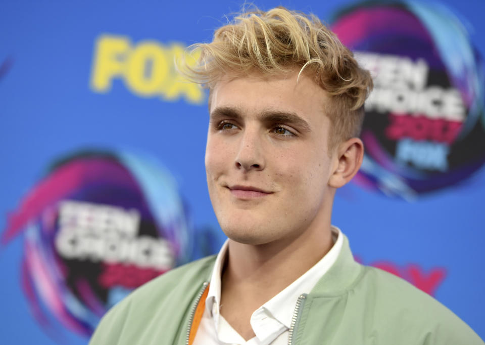 FILE - Internet personality Jake Paul arrives at the Teen Choice Awards in Los Angeles on Aug. 13, 2017. FBI agents including a SWAT team have raided the apparent home of YouTube star Jake Paul. FBI spokeswoman Laura Eimiller says agents executed a search warrant Wednesday at the Calabasas, California mansion in connection with an ongoing investigation. She could not say what the probe is about or who the target was. Helicopter video from local TV news showed agents gathering guns from the home that can frequently be seen on Paul's YouTube channel, which has over 20 million followers. (Photo by Jordan Strauss/Invision/AP, File)