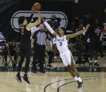 Oklahoma State guard Cade Cunningham (2) shoots a three point shot over Baylor guard MaCio Teague (31) in the second half of an NCAA college basketball game, Thursday, March 4, 2021, in Waco, Texas. (AP Photo/Jerry Larson)