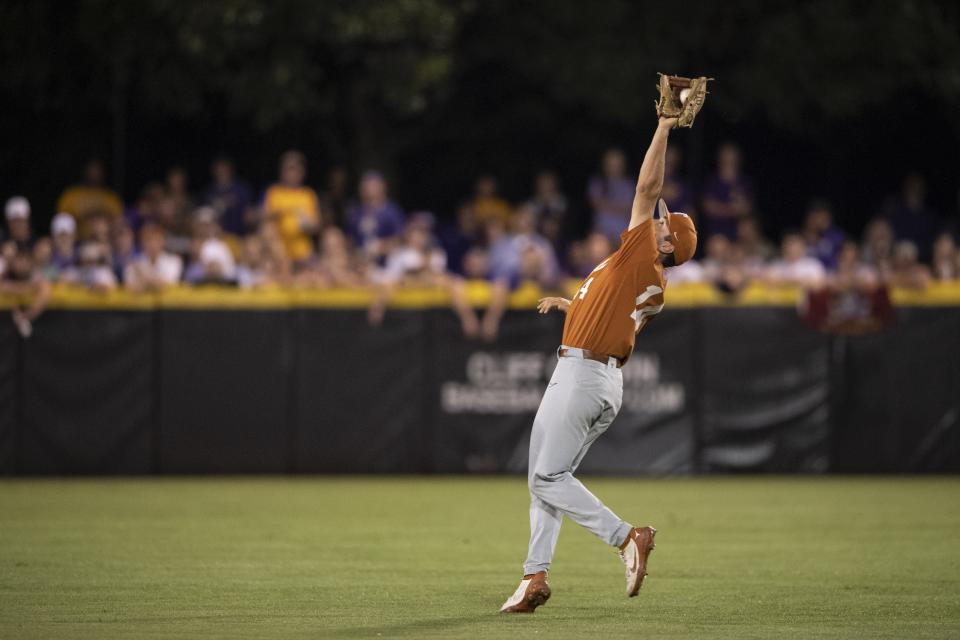 Murphy Stehly catches a fly ball hit by East Carolina's Jacob Starling in the second inning Sunday. The Longhorns will make their NCAA-record 38th trip to the College World Series later this week.