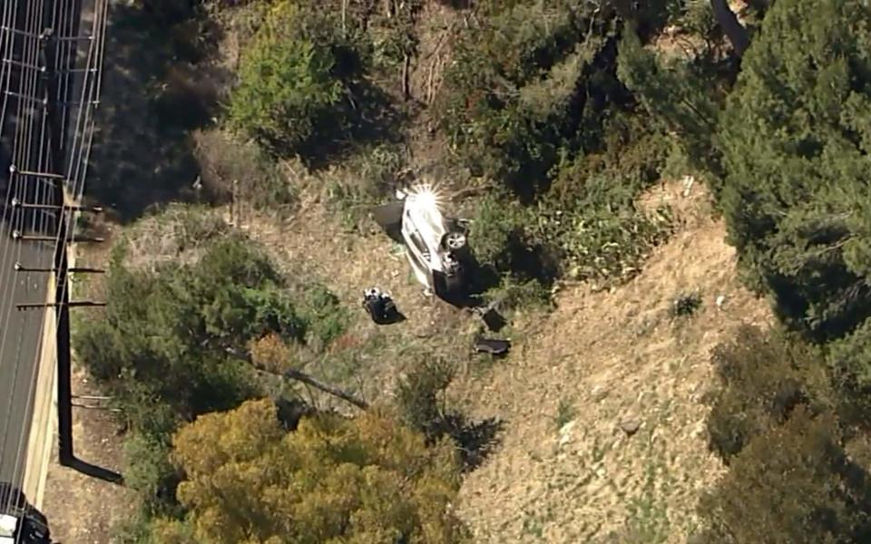 Woods' car on its side off the road in Rancho Palos Verdes - AP