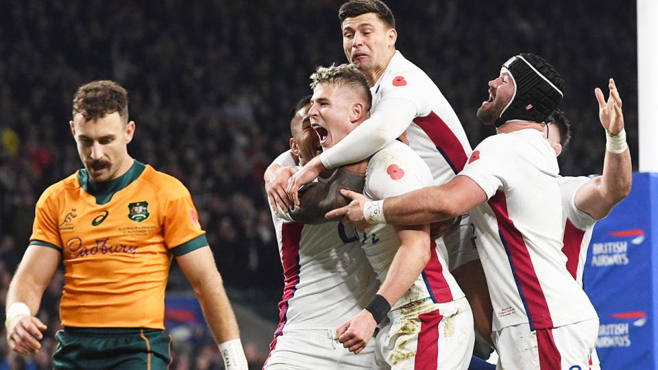 Seen here, England players celebrate during their rugby Test win against the Wallabies at Twickenham.