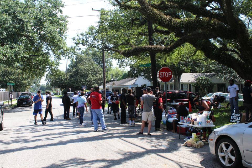 Dozens gather near the Lafayette Police Department headquarters for a barbecue after they were unable to file a complaint regarding excessive force on Labor Day.