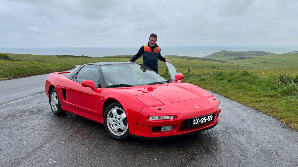 Automotive journalist Ben Oliver stands beside a 1991 Acura NSX that once belonged to Formula 1 racer Ayrton Senna.
