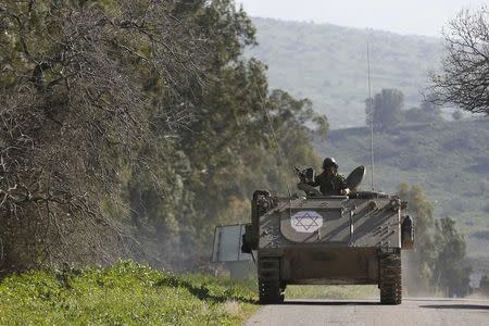 An Israeli soldier rides an armoured military ambulance Israel's border with Lebanon January 28, 2015. REUTERS/Baz Ratner