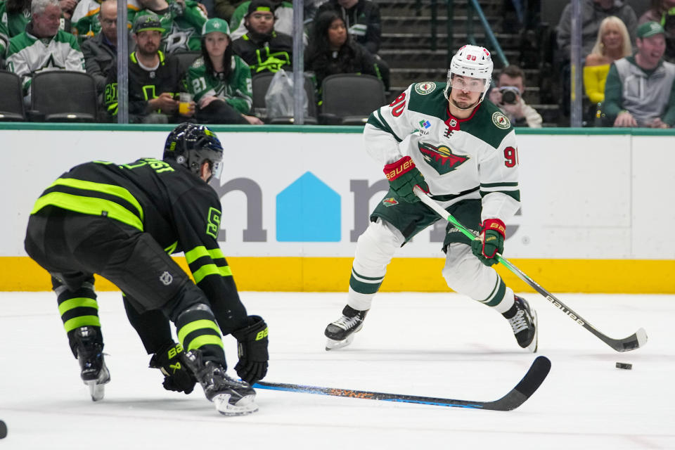 Minnesota Wild left wing Marcus Johansson (90) skates with the puck against Dallas Stars defenseman Nils Lundkvist (5) during the second period of an NHL hockey game, Wednesday, Jan. 10, 2024, in Dallas. (AP Photo/Julio Cortez)