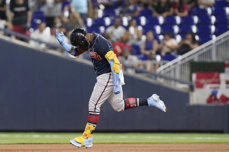 Atlanta Braves' Ronald Acuna Jr. celebrates as he heads to second base after hitting a home run during the first inning of the second game of a baseball doubleheader against the Miami Marlins, Saturday, Aug. 13, 2022, in Miami. (AP Photo/Wilfredo Lee)