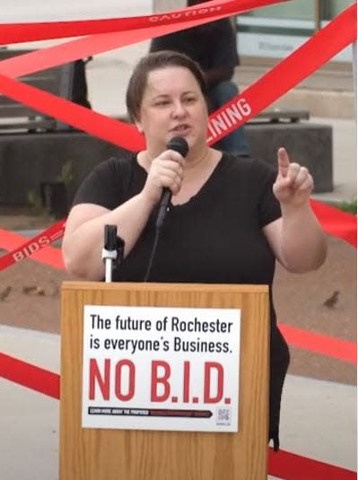 The movement against Rochester's proposed downtown Business Improvement District held a community demonstration in July 2023. Kelly Cheatle, a local art director, was among the people who shared remarks by the Liberty Pole in downtown Rochester.