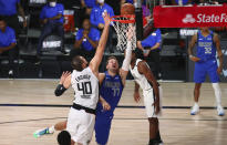 Los Angeles Clippers center Ivica Zubac (40) defends against Dallas Mavericks guard Luka Doncic (77) during the second half of Game 5 of an NBA basketball first-round playoff series, Tuesday, Aug. 25, 2020, in Lake Buena Vista, Fla. (Kim Klement/Pool Photo via AP)