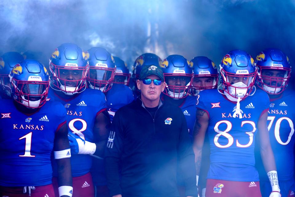LAWRENCE, KS - NOVEMBER 05: Head coach Lance Leipold of the Kansas Jayhawks stands with his team as they wait to take to the field prior to a game against the Oklahoma State Cowboys at David Booth Kansas Memorial Stadium on November 5, 2022 in Lawrence, Kansas. (Photo by Ed Zurga/Getty Images) *** BESTPIX ***