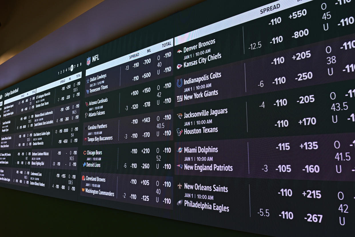 An odds board at a sports book shows the various odds for games around the sporting world, including that week's NFL games. (AP Photo/David Dermer, File)