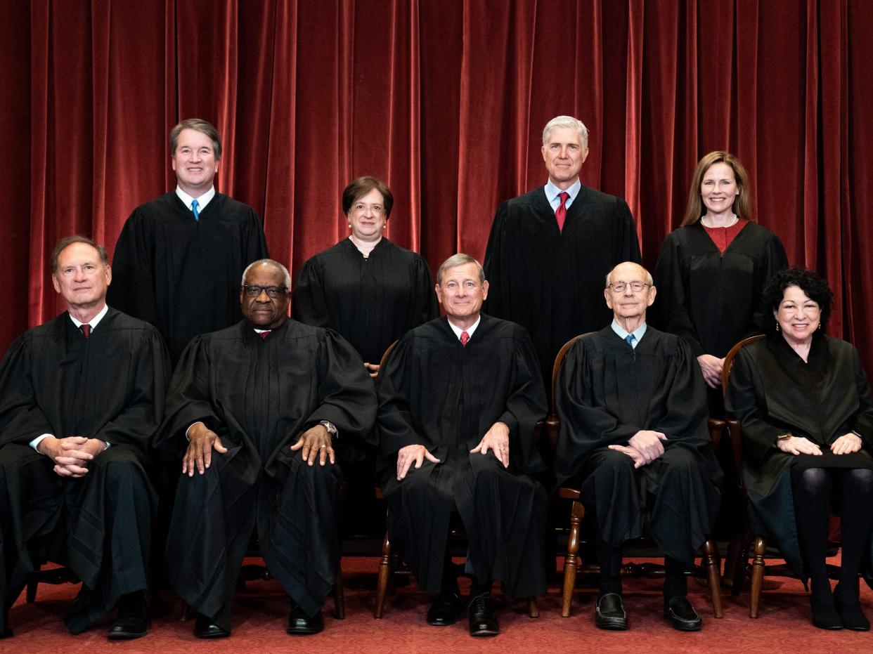 Seated from left: Associate Justice Samuel Alito, Associate Justice Clarence Thomas, Chief Justice John Roberts, Associate Justice Stephen Breyer and Associate Justice Sonia Sotomayor, standing from left: Associate Justice Brett Kavanaugh, Associate Justice Elena Kagan, Associate Justice Neil Gorsuch and Associate Justice Amy Coney Barrett pose during a group photo of the Justices at the Supreme Court in Washington, DC on 23 April 2021 (ERIN SCHAFF/POOL/AFP via Getty Images)