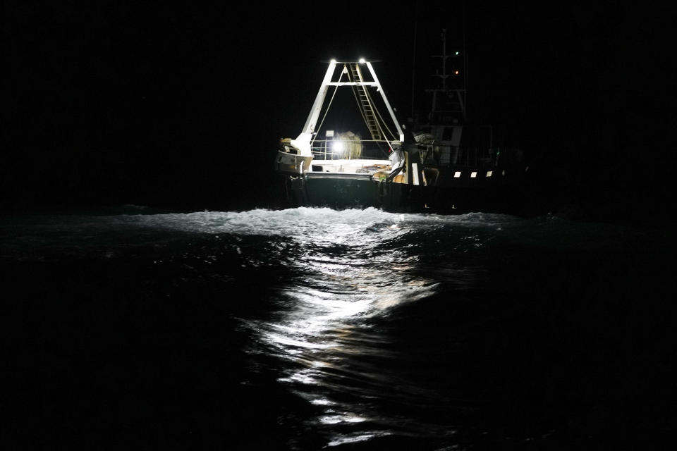 A fishing boat is seen from aboard the trawler Marianna, as it leaves Fiumicino port to go out at sea for a fishing trip, in the Tyrrhenian Sea, late Wednesday night, April 1, 2020. Italy’s fishermen still go out to sea at night, but not as frequently in recent weeks since demand is down amid the country's devastating coronavirus outbreak. For one night, the Associated Press followed Pasquale Di Bartolomeo and his crew consisting of his brother Francesco and another fishermen, also called Francesco, on their trawler Marianna. (AP Photo/Andrew Medichini)